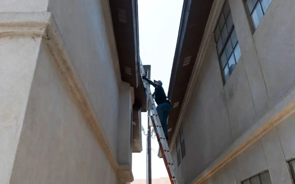 How to Safely Get Up and Walk on Your Roof Using a Ladder